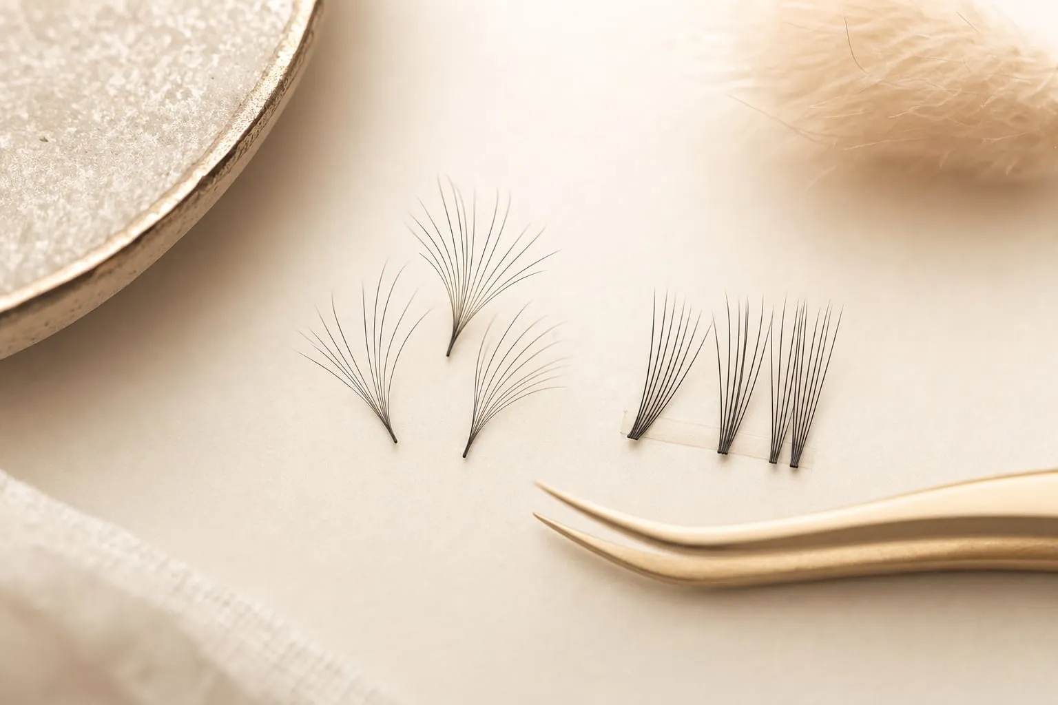 Artist handcrafting a volume lash fan for a single natural lash